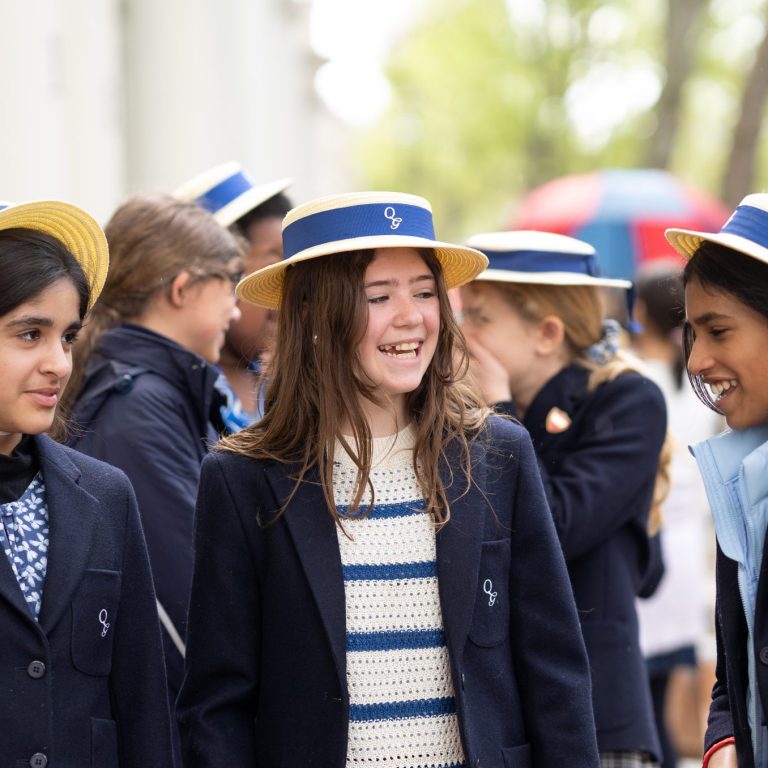 Queen's gate Junior School girls outside in boaters and blazers