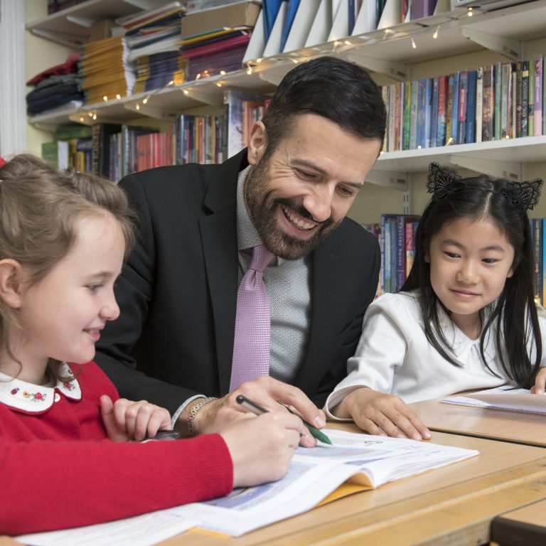 Queen's Gate Junior School girls in lesson with maths teacher